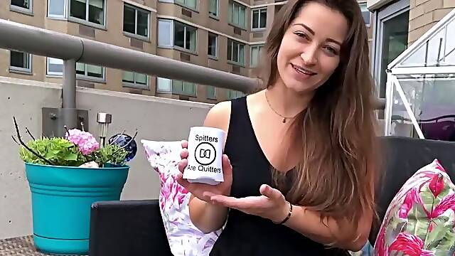 Funny brown haired girl in dark-hued top on balcony